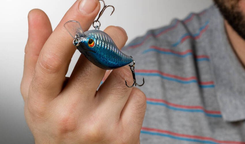 stock photo fishing lure stuck mans finger background gray blurred 